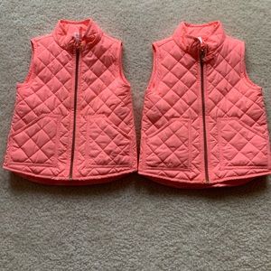 Twin girls matching pink puffy vests